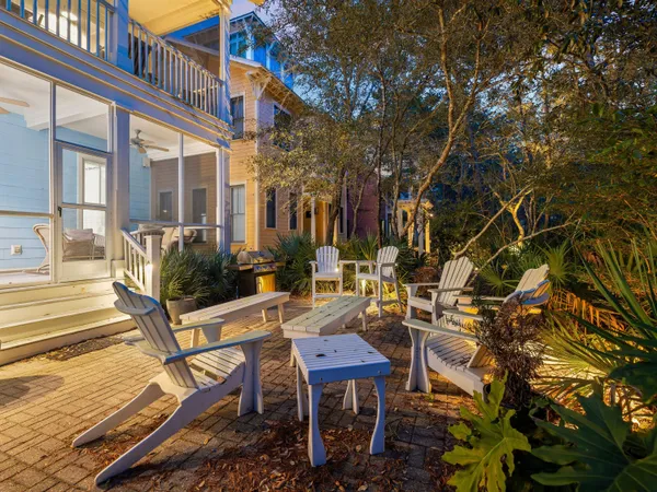 a view of a patio with table and chairs and potted plants
