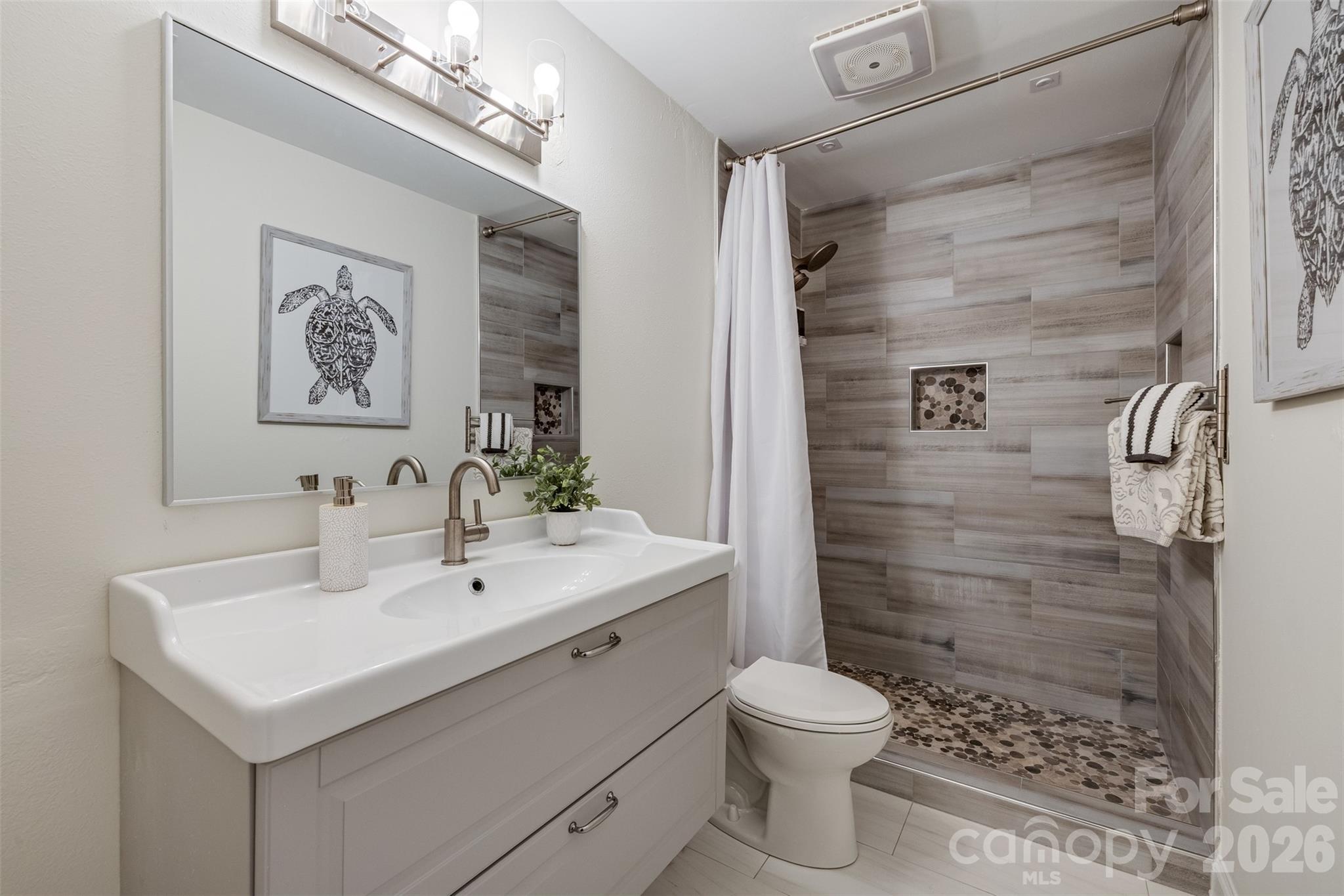 8 Hickory Ridge Court Lake Wylie, SC 29710 - Photo 22 of 37 a bathroom with a sink a toilet and shower