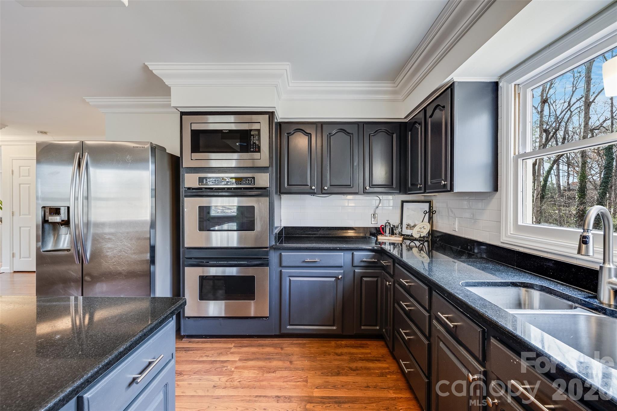 8 Hickory Ridge Court Lake Wylie, SC 29710 - Photo 8 of 37 a kitchen with granite countertop a refrigerator and a sink