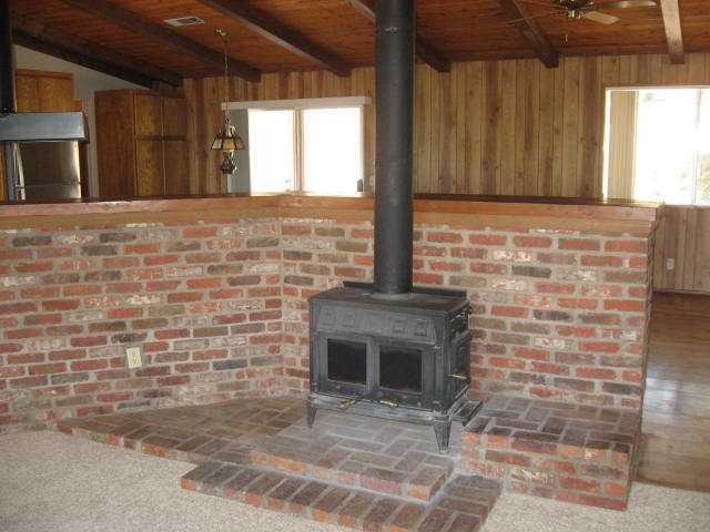 14281 Cane Road Valley Center, CA 92082 - Photo 9 of 24 Wood burning stove in LR. Family room other side of wall.