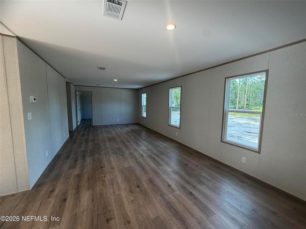 114 Nutmeg Trail Interlachen, FL 32148 - Photo 28 of 33 a view of empty room with window and wooden floor