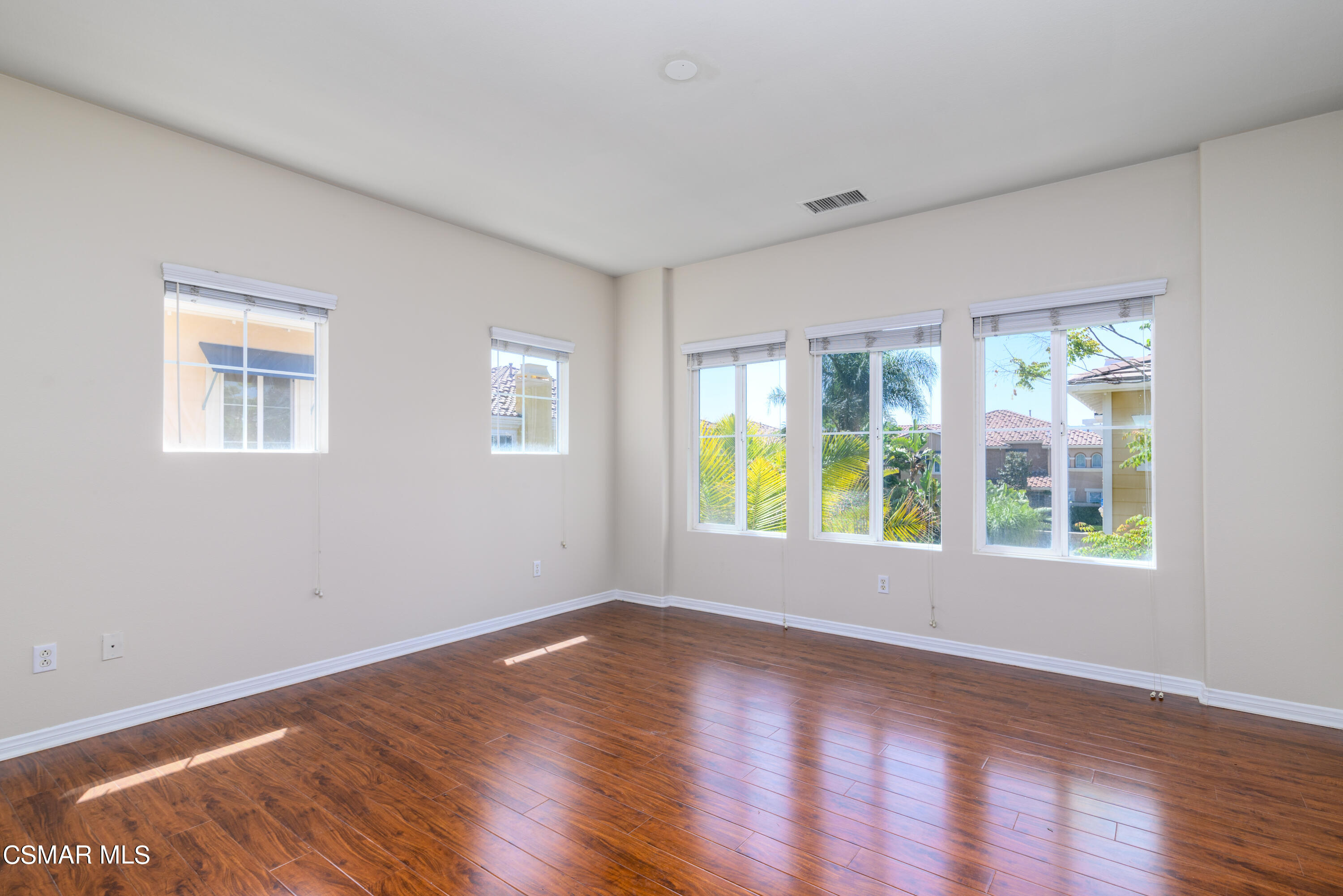 4120 Paredo Way, Unit C Simi Valley, CA 93063 - Photo 11 of 24 a view of an empty room with wooden floor and a window