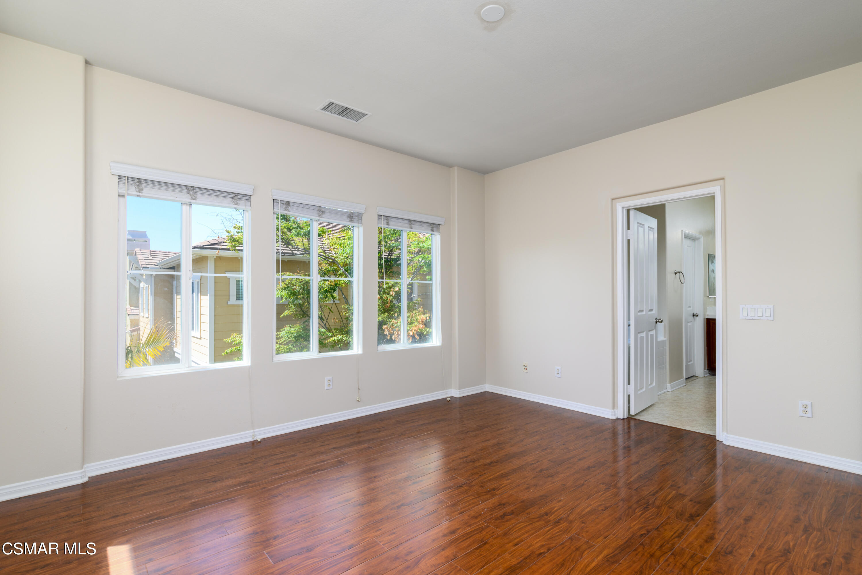 4120 Paredo Way, Unit C Simi Valley, CA 93063 - Photo 12 of 24 a view of an empty room with wooden floor and windows