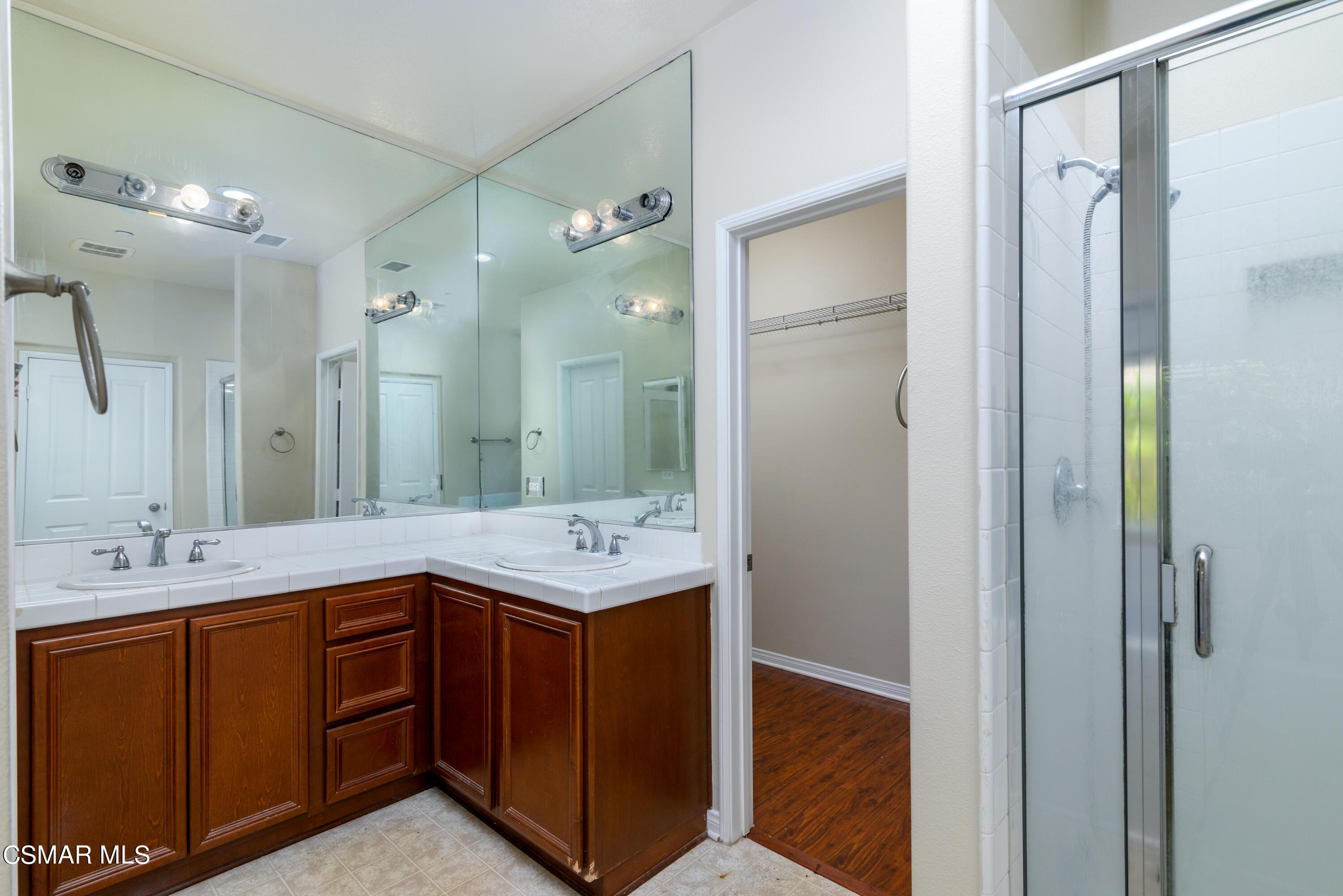 4120 Paredo Way, Unit C Simi Valley, CA 93063 - Photo 15 of 24 a bathroom with a double vanity sink and mirror