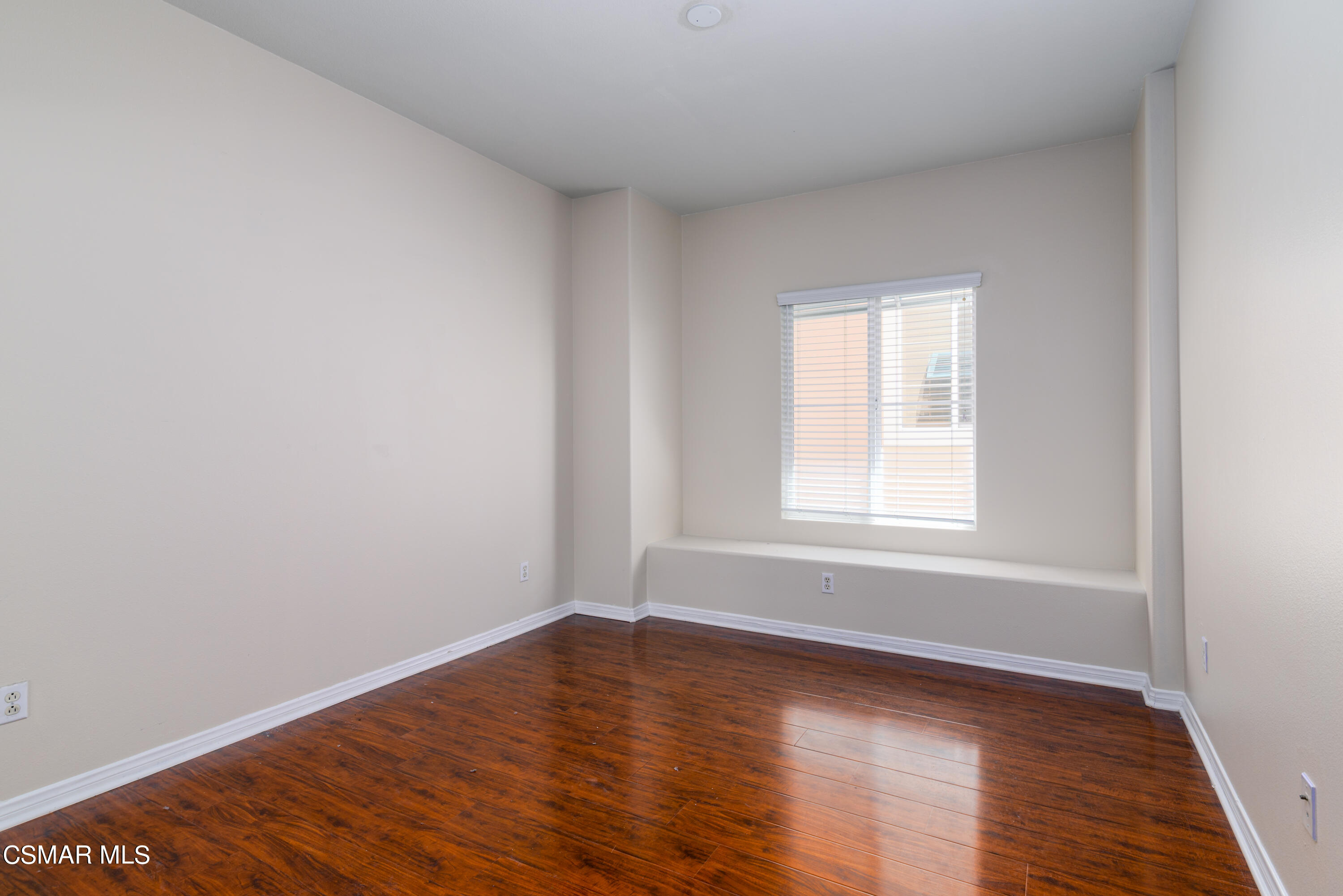 4120 Paredo Way, Unit C Simi Valley, CA 93063 - Photo 17 of 24 a view of an empty room with wooden floor and a window