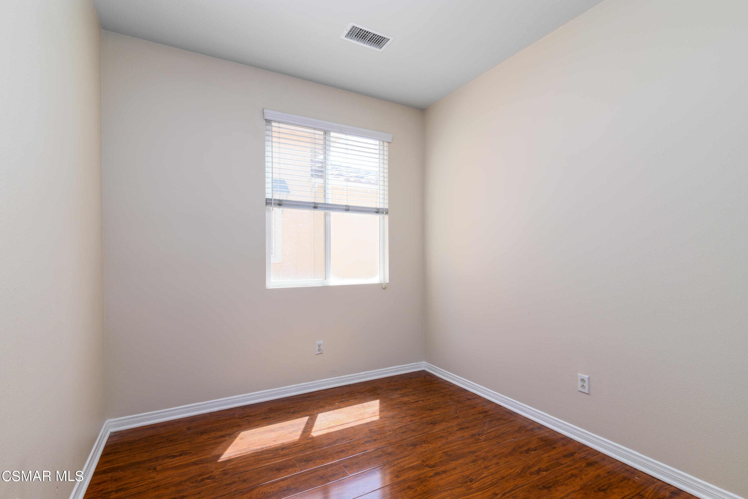 4120 Paredo Way, Unit C Simi Valley, CA 93063 - Photo 18 of 24 an empty room with wooden floor and windows