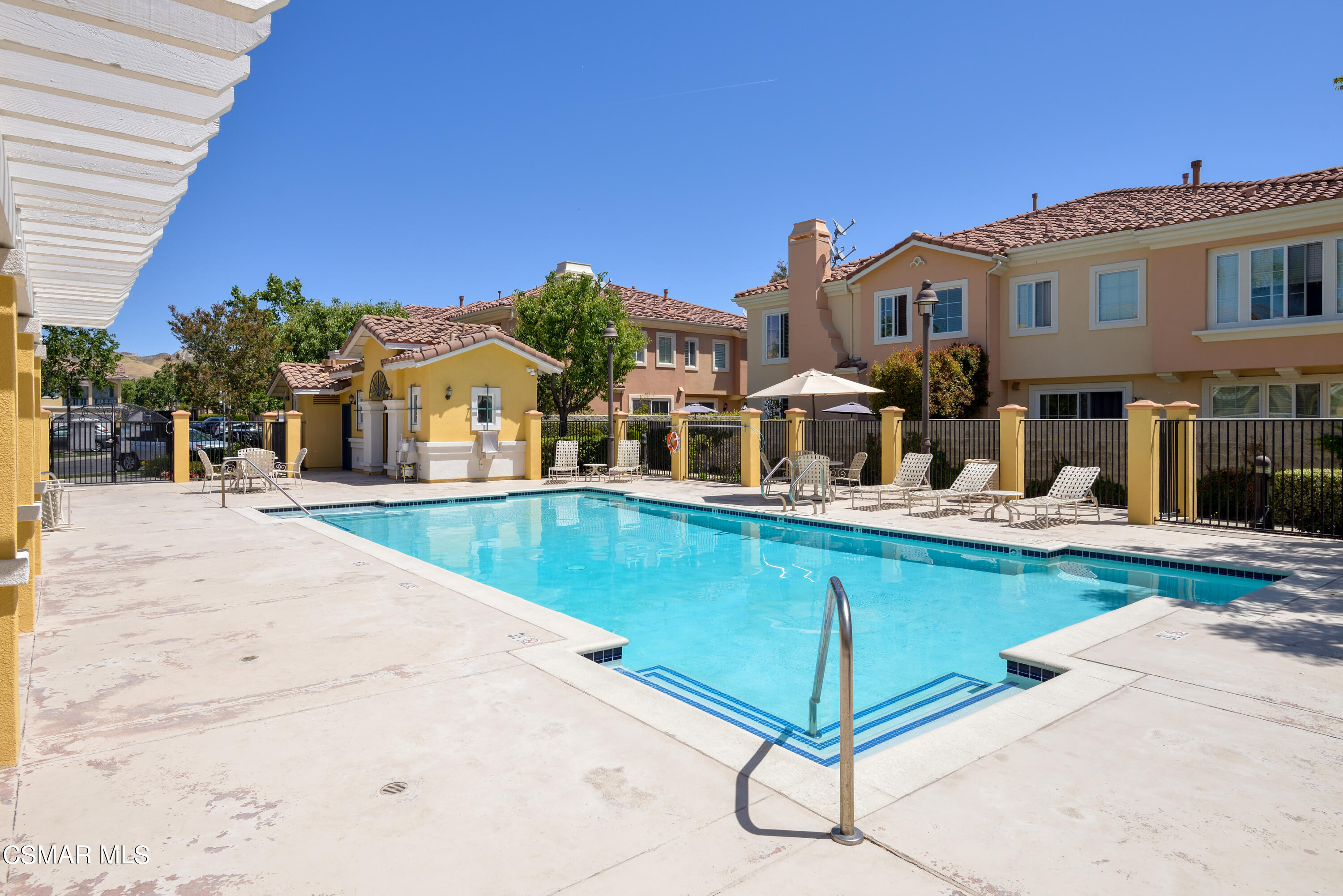 4120 Paredo Way, Unit C Simi Valley, CA 93063 - Photo 24 of 24 a view of a swimming pool with a lawn chairs under an umbrella
