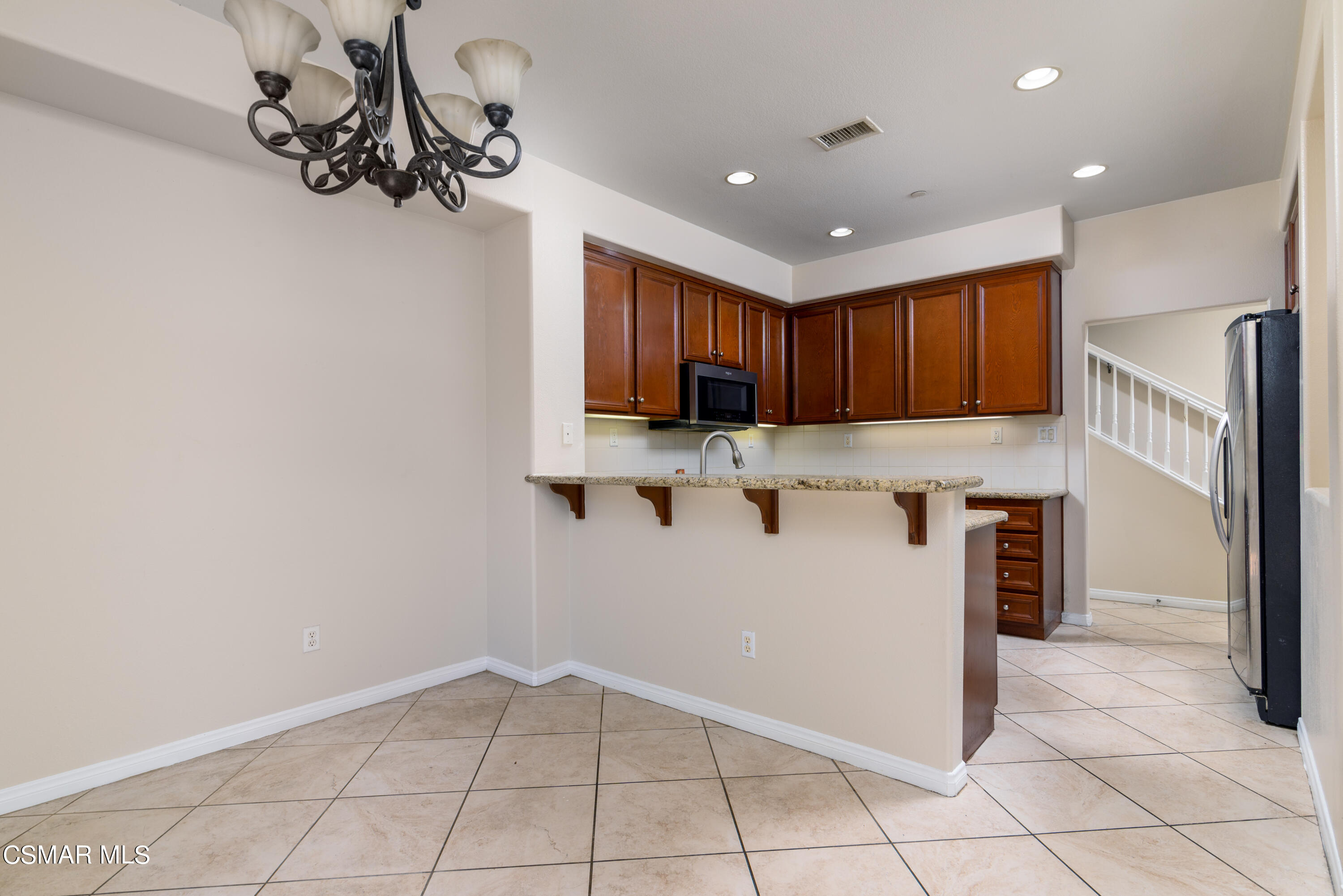 4120 Paredo Way, Unit C Simi Valley, CA 93063 - Photo 6 of 24 a kitchen with granite countertop a refrigerator a stove top oven a sink and dishwasher