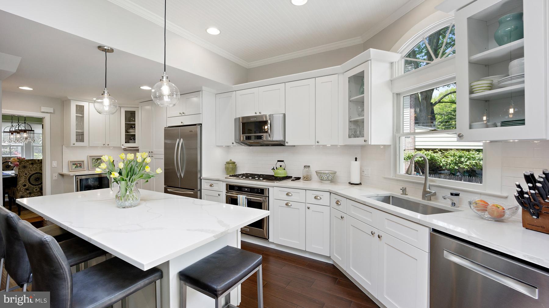 517 Monroe Road Merion Station, PA 19066 - Photo 16 of 40 a kitchen with stainless steel appliances a table chairs sink and cabinets
