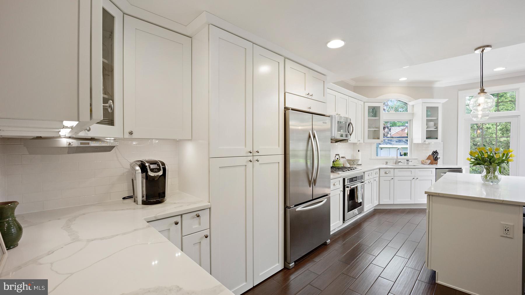 517 Monroe Road Merion Station, PA 19066 - Photo 18 of 40 a kitchen with white cabinets and stainless steel appliances