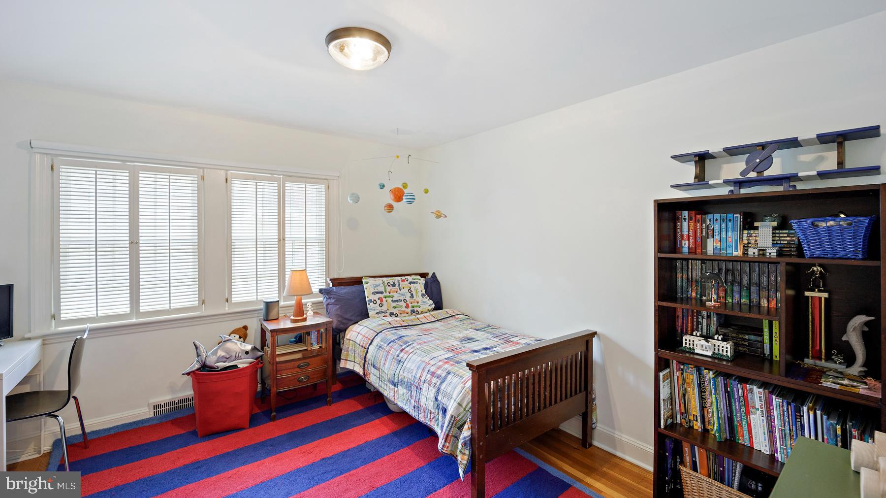 517 Monroe Road Merion Station, PA 19066 - Photo 27 of 40 a bedroom with furniture window and book shelf