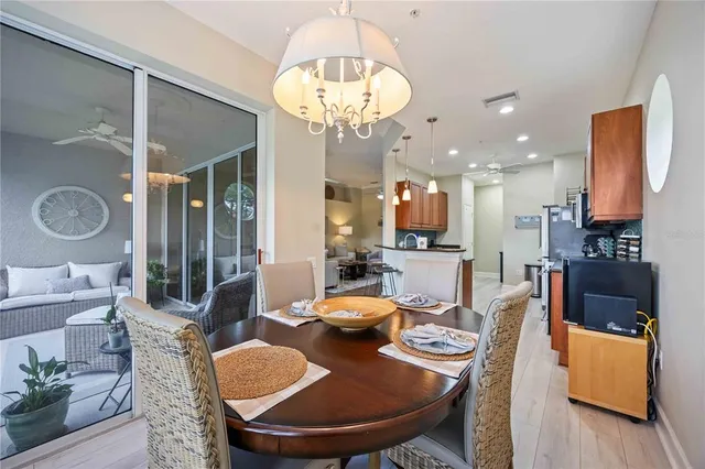 a dining room with furniture a large window and kitchen view