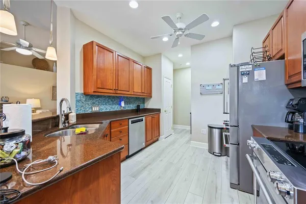 a kitchen with a sink appliances and cabinets