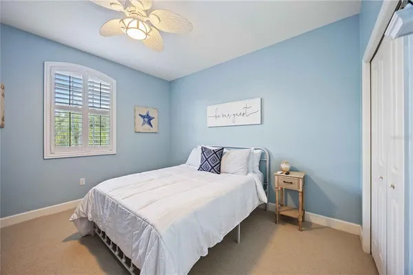 a bedroom with bed and a window