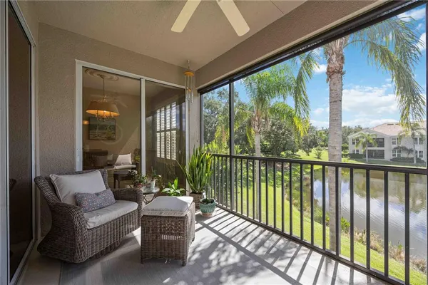 a balcony with furniture and a potted plant