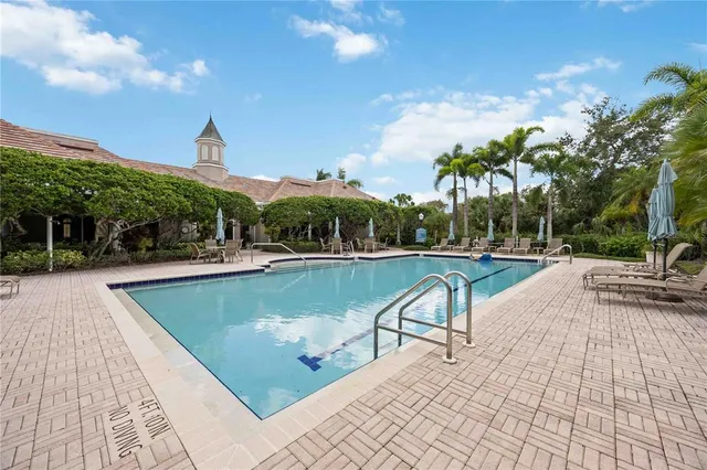 a view of a swimming pool with a patio and a garden