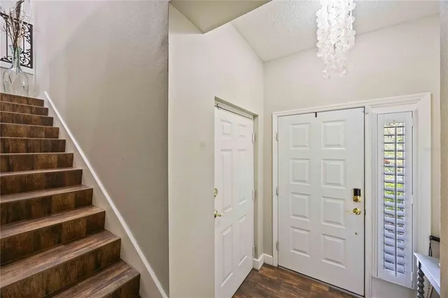 a view of a hallway with wooden floor and entryway
