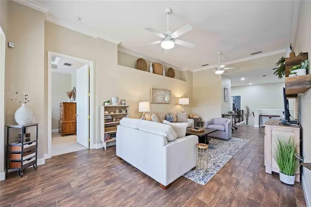 a living room with furniture and a chandelier