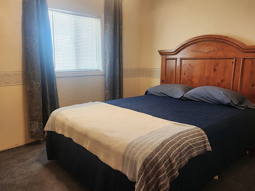 8257 Green Valley Road Mohave Valley, AZ 86440 - Photo 28 of 41 Guest bedroom with horizontal blinds and patterned privacy drapes