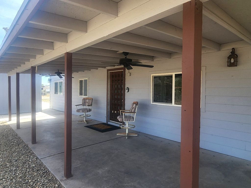 8257 Green Valley Road Mohave Valley, AZ 86440 - Photo 8 of 41 Expansive covered patio featuring multiple ceiling fans, recessed lighting, and a textured wood entry door