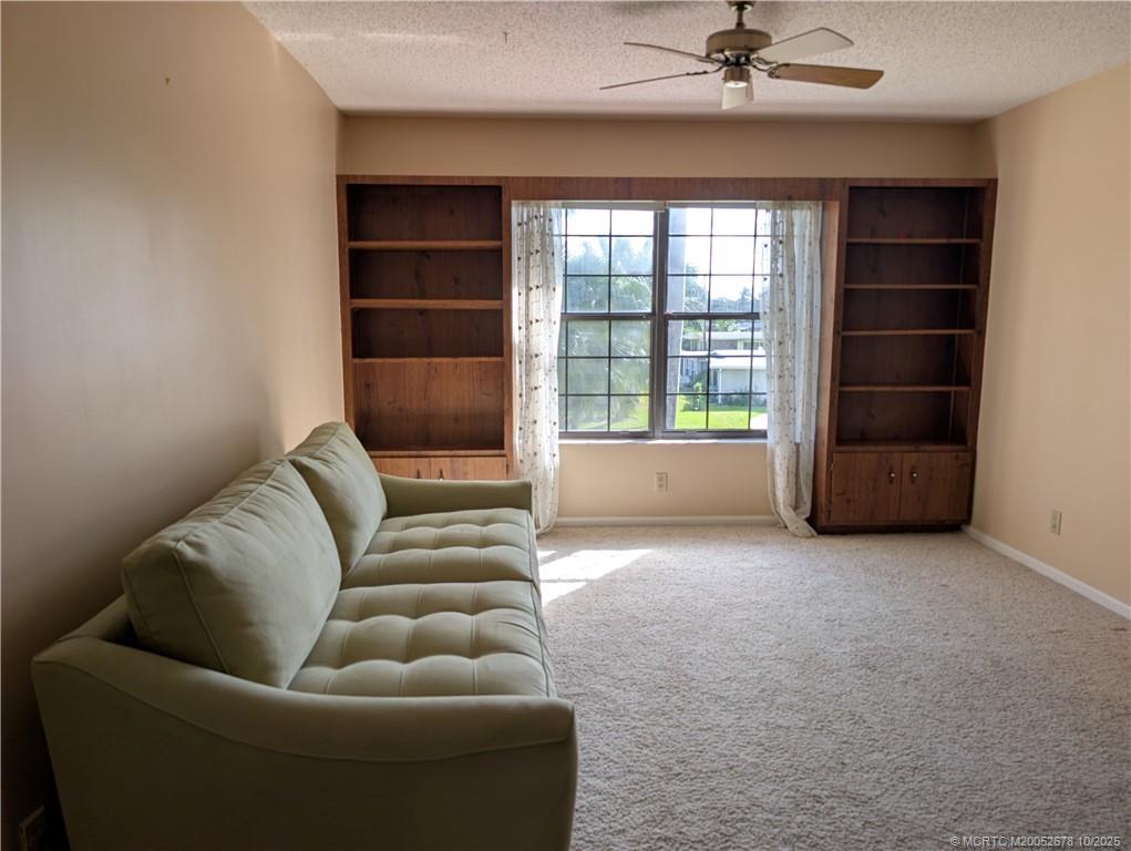 3100 Southeast Pruitt Road, Unit B301 Port St. Lucie, FL 34952 - Photo 12 of 48 a living room with furniture and a window
