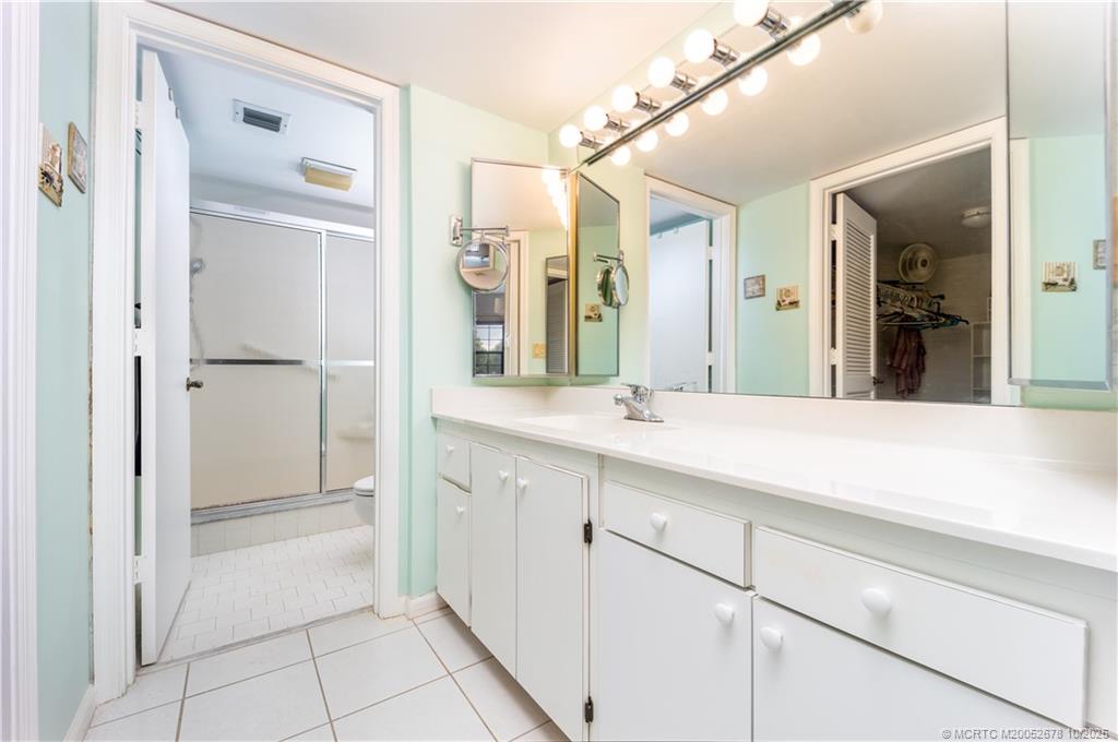 3100 Southeast Pruitt Road, Unit B301 Port St. Lucie, FL 34952 - Photo 22 of 48 a spacious bathroom with a shower a sink and a mirror