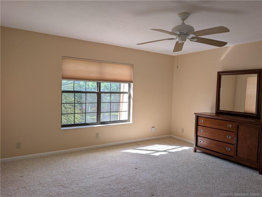 3100 Southeast Pruitt Road, Unit B301 Port St. Lucie, FL 34952 - Photo 25 of 48 an empty room with fan and windows