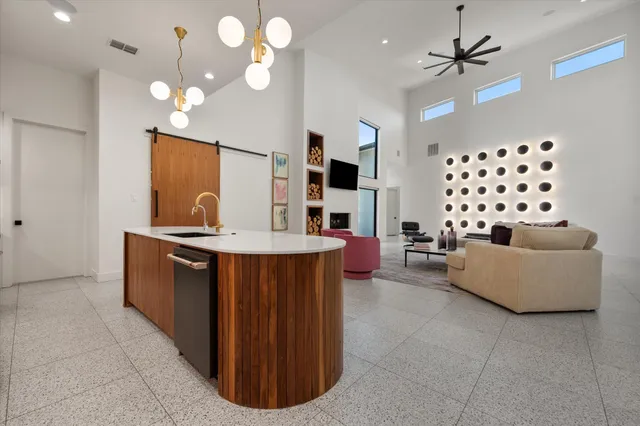 a living room with granite countertop furniture and a chandelier