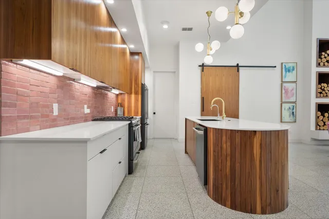 a large kitchen with kitchen island a sink stainless steel appliances and cabinets