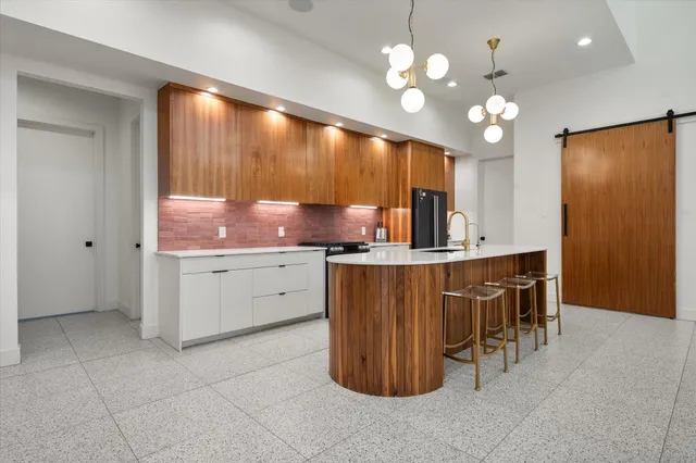 a kitchen with cabinets a sink and appliances