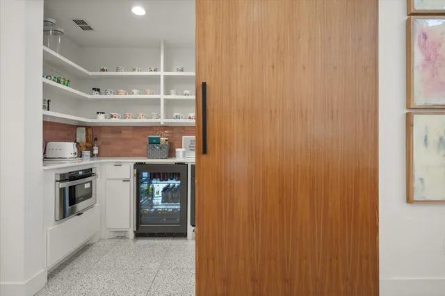 a kitchen with cabinets and stainless steel appliances