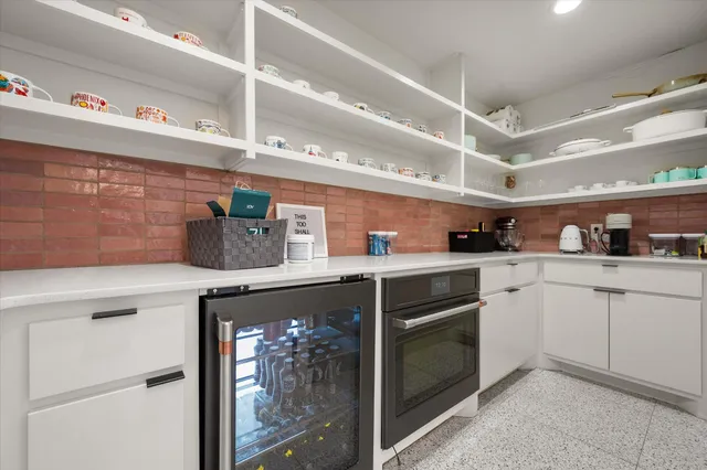 a kitchen with cabinets and white stainless steel appliances