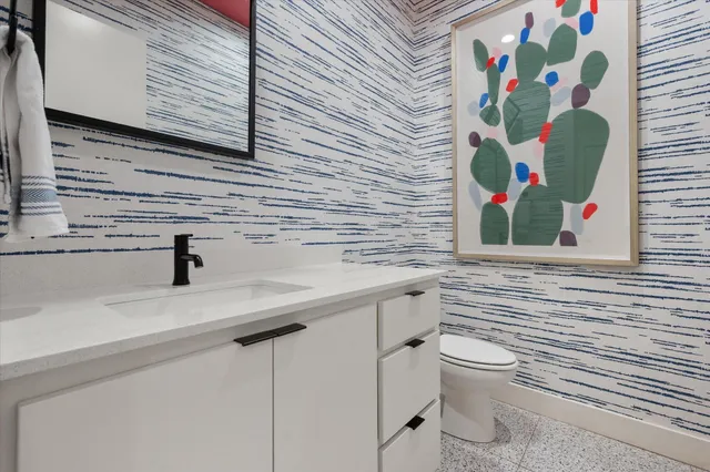 a bathroom with a toilet sink and mirror