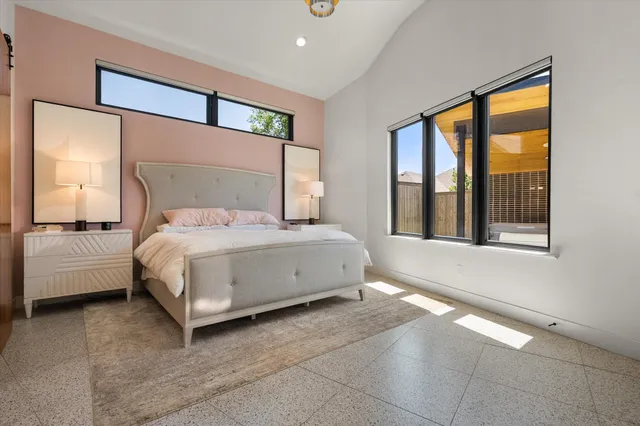 a spacious bedroom with a bed and large mirror