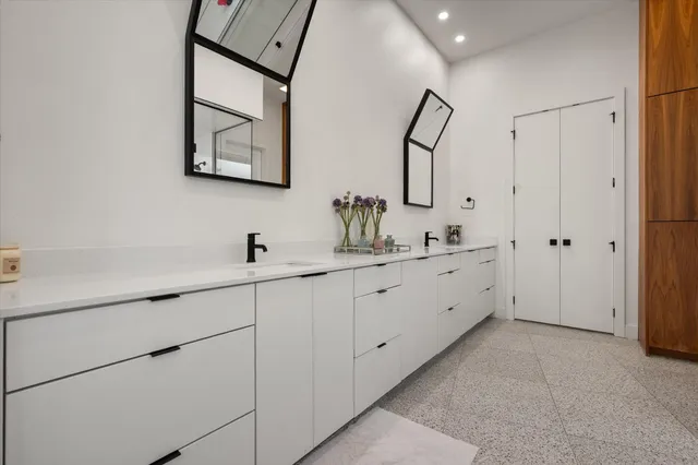 a bathroom with a shower sink and mirror