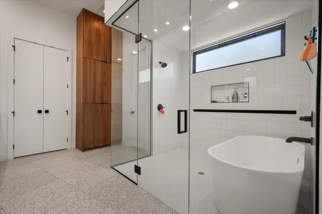 a bathroom with a bathtub and a shower
