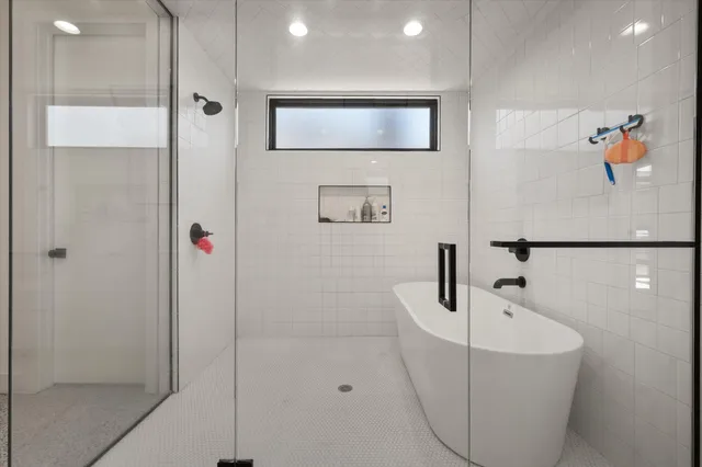 a bathroom with a tub and mirror