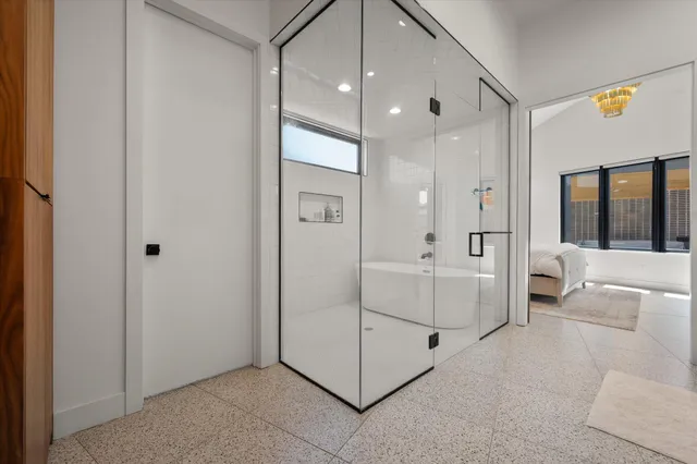 a spacious en suite bathroom with a double vanity sink and a mirror