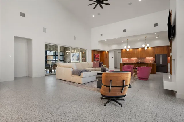 a living room with furniture and a view of kitchen