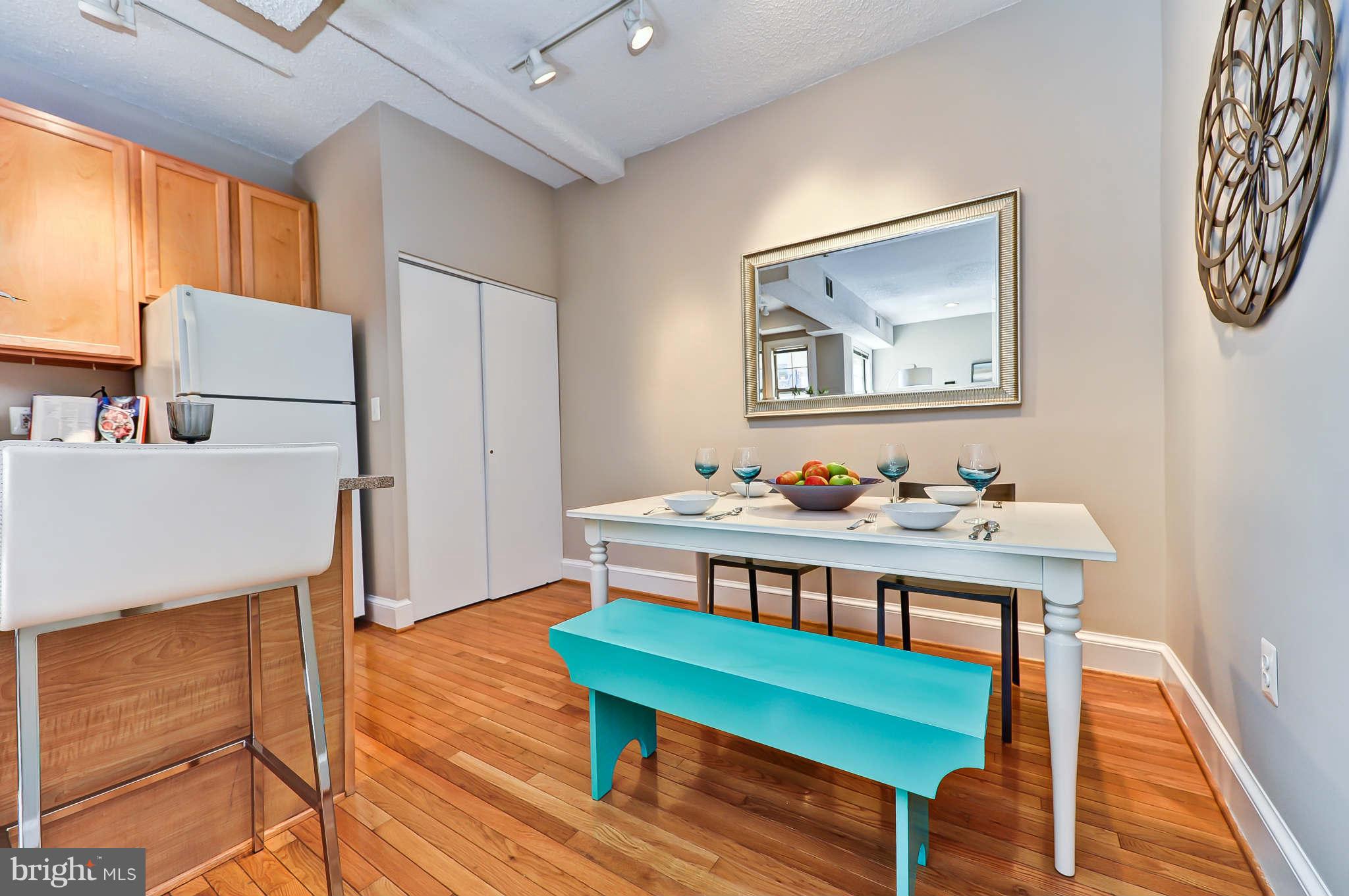 1401 Columbia Road Northwest, Unit 302 Washington, DC 20009 - Photo 11 of 30 a view of a room with furniture and wooden floor