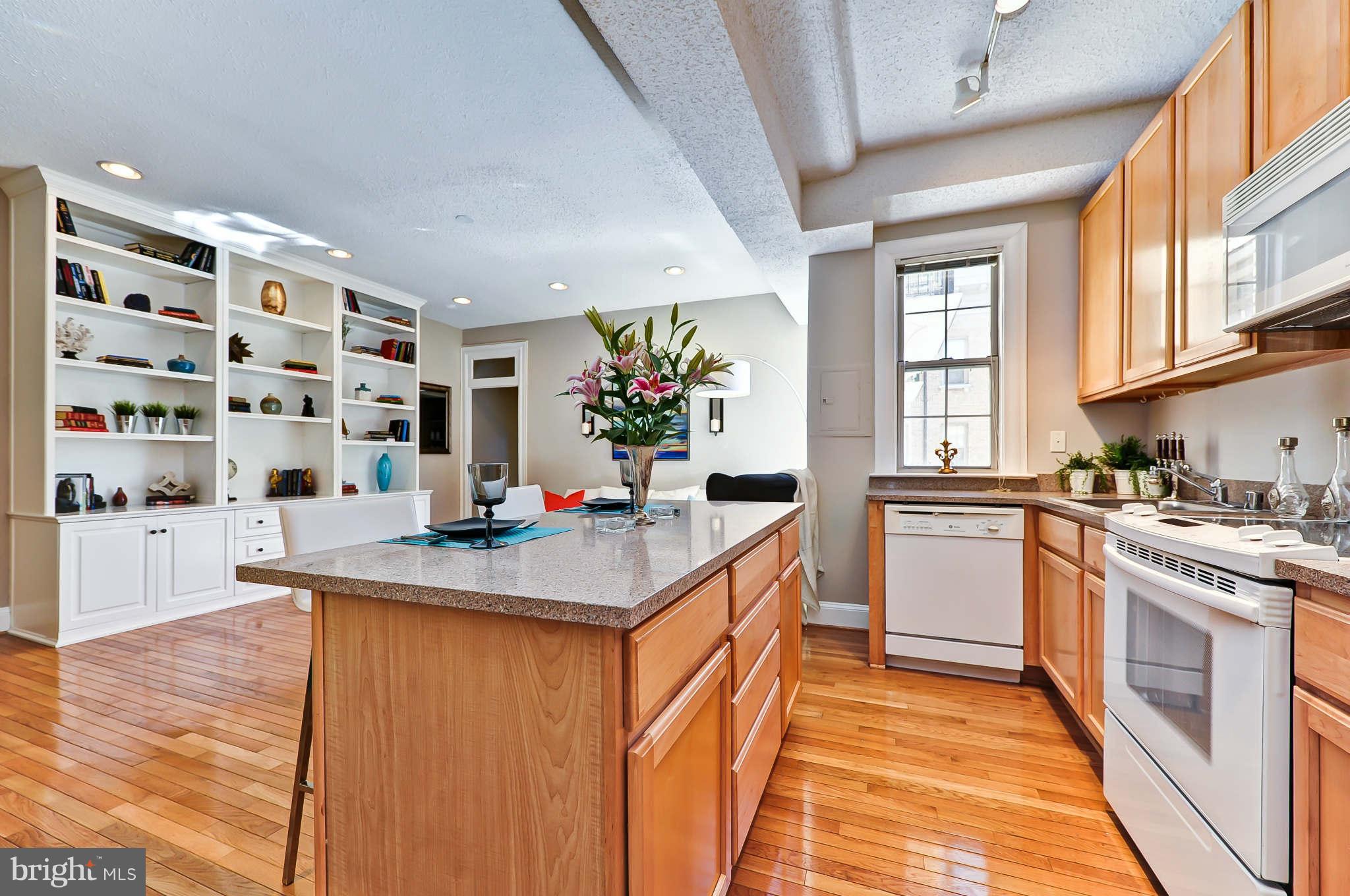 1401 Columbia Road Northwest, Unit 302 Washington, DC 20009 - Photo 18 of 30 a kitchen with stainless steel appliances granite countertop a sink stove and cabinets