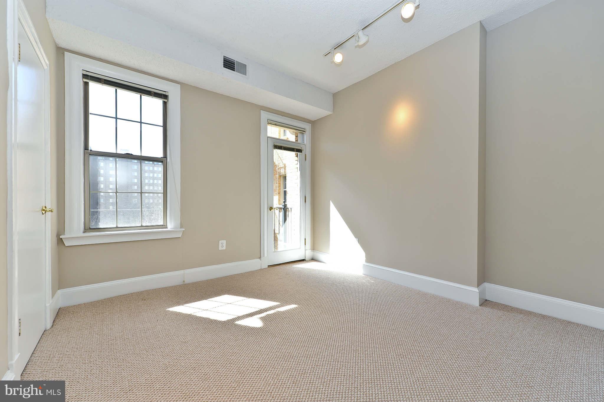 1401 Columbia Road Northwest, Unit 302 Washington, DC 20009 - Photo 23 of 30 an empty room with windows