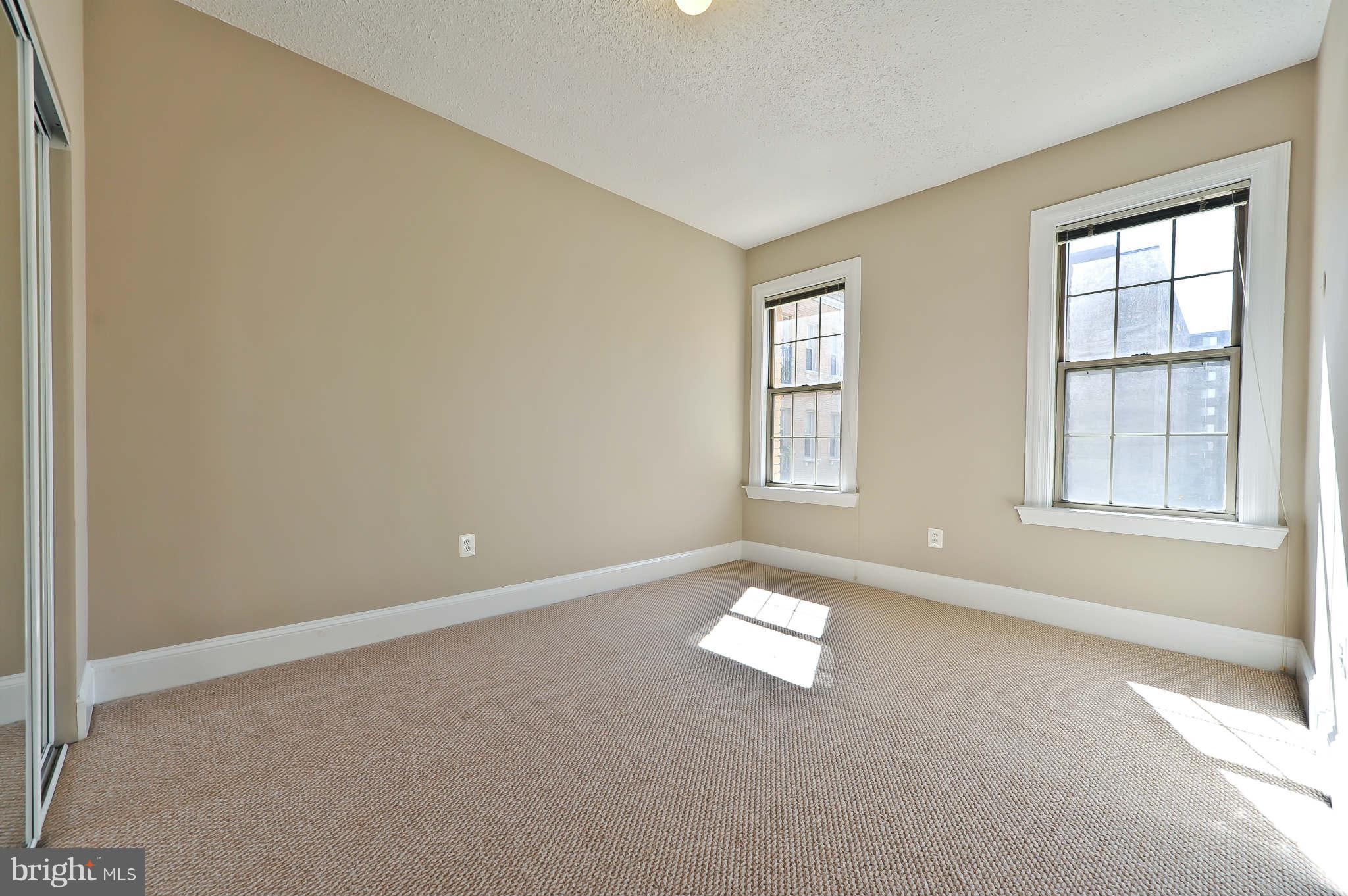 1401 Columbia Road Northwest, Unit 302 Washington, DC 20009 - Photo 25 of 30 an empty room with windows