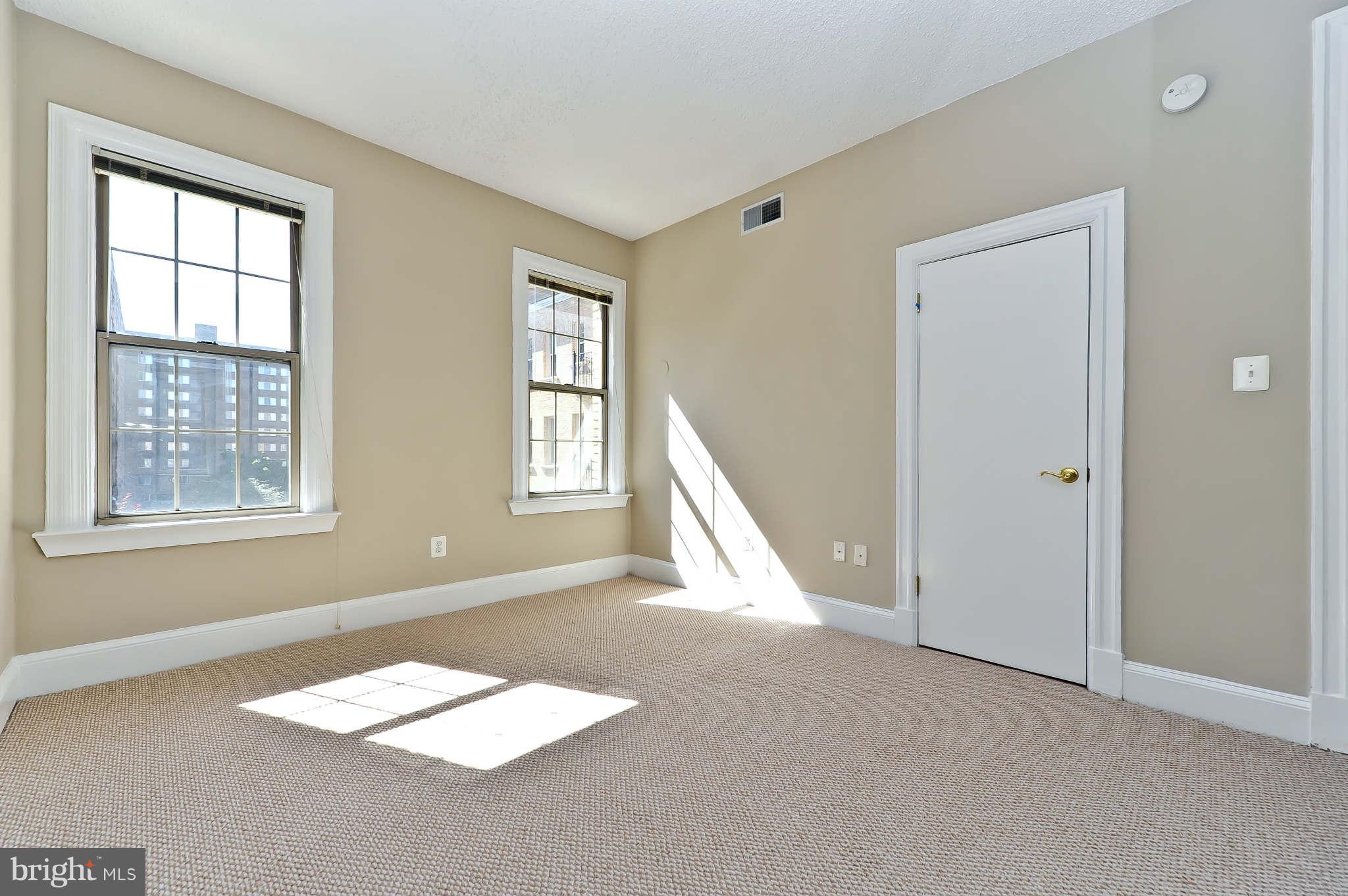 1401 Columbia Road Northwest, Unit 302 Washington, DC 20009 - Photo 26 of 30 an empty room with windows
