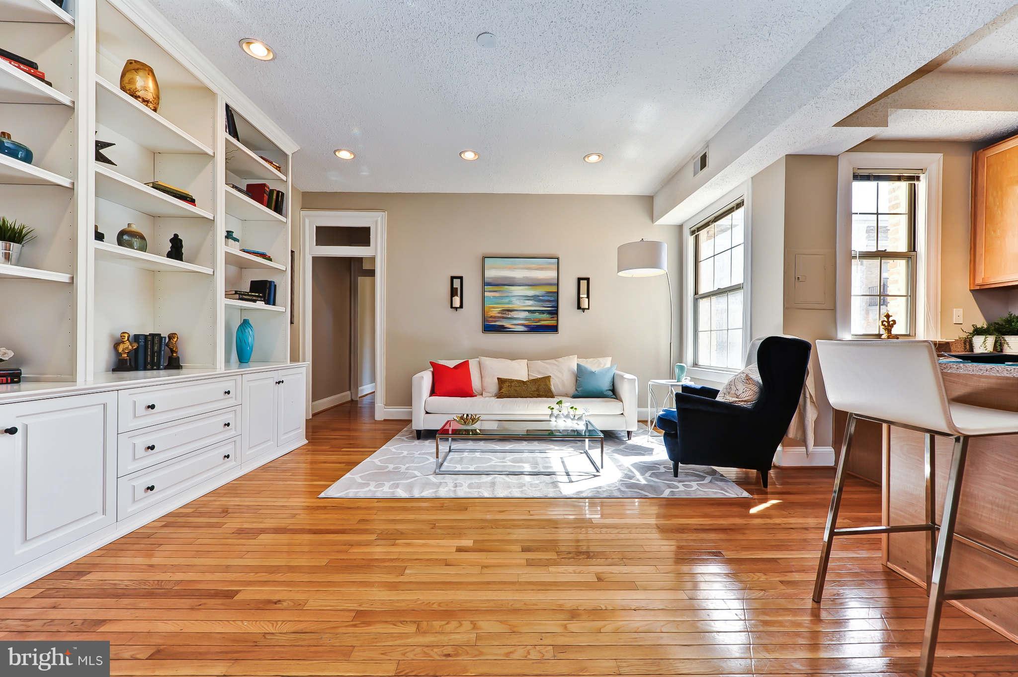 1401 Columbia Road Northwest, Unit 302 Washington, DC 20009 - Photo 5 of 30 a living room with furniture and wooden floor
