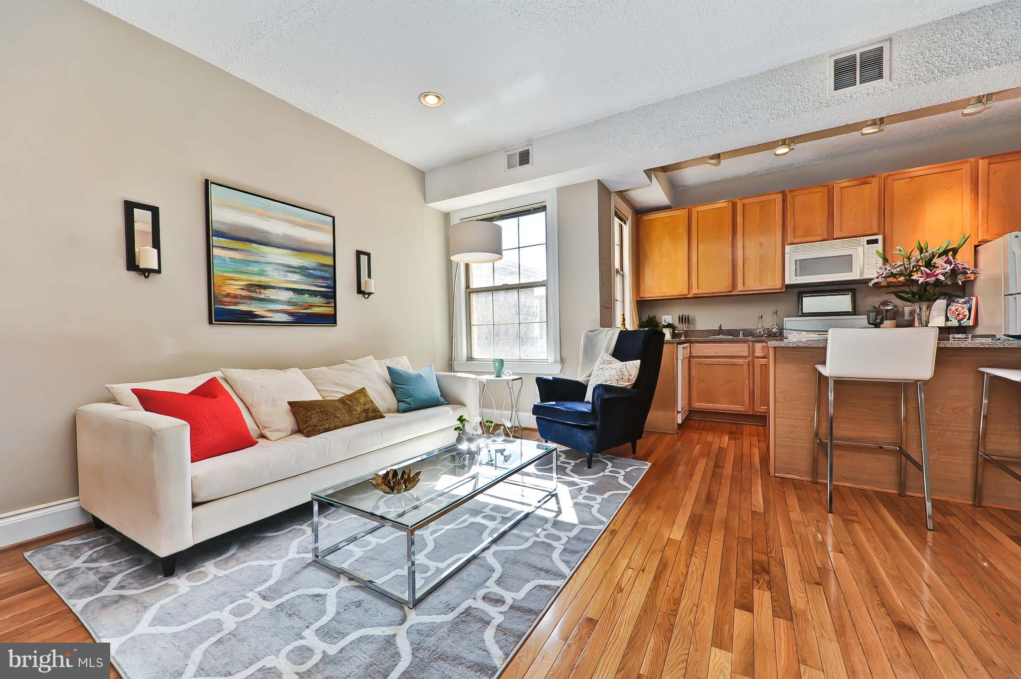 1401 Columbia Road Northwest, Unit 302 Washington, DC 20009 - Photo 10 of 30 a living room with furniture and large windows