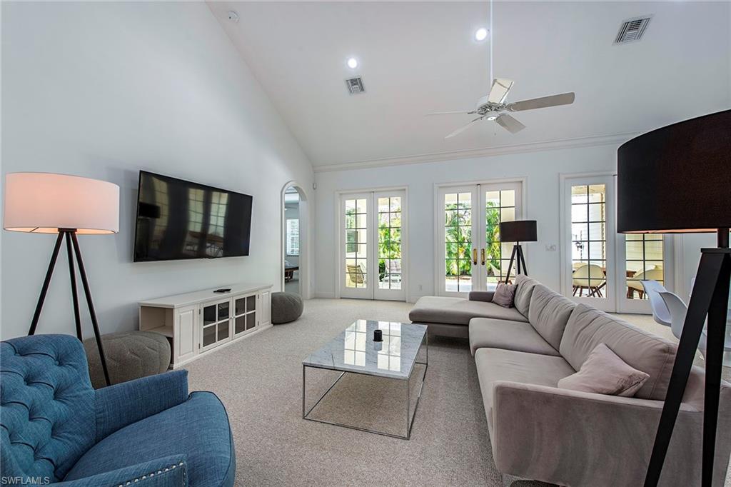 860 7th Street South Naples, FL 34102 - Photo 2 of 13 a living room with furniture flat screen tv and a large window