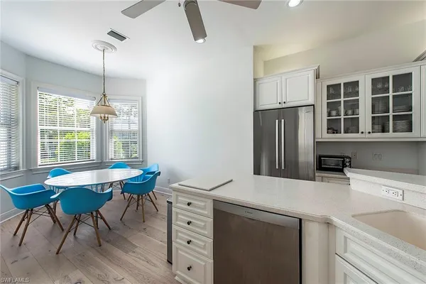 a kitchen with refrigerator cabinets and wooden floor