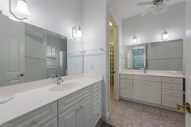 a bathroom with a sink double vanity and a mirror