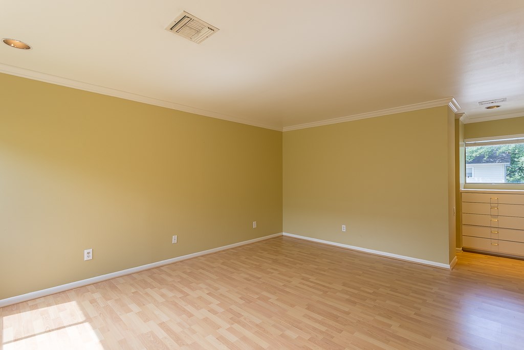 2349 Albans Road, Unit 2 Houston, TX 77005 - Photo 18 of 25 Discover the spacious primary bedroom, featuring elegant built-in drawers that offer both style and ample storage.